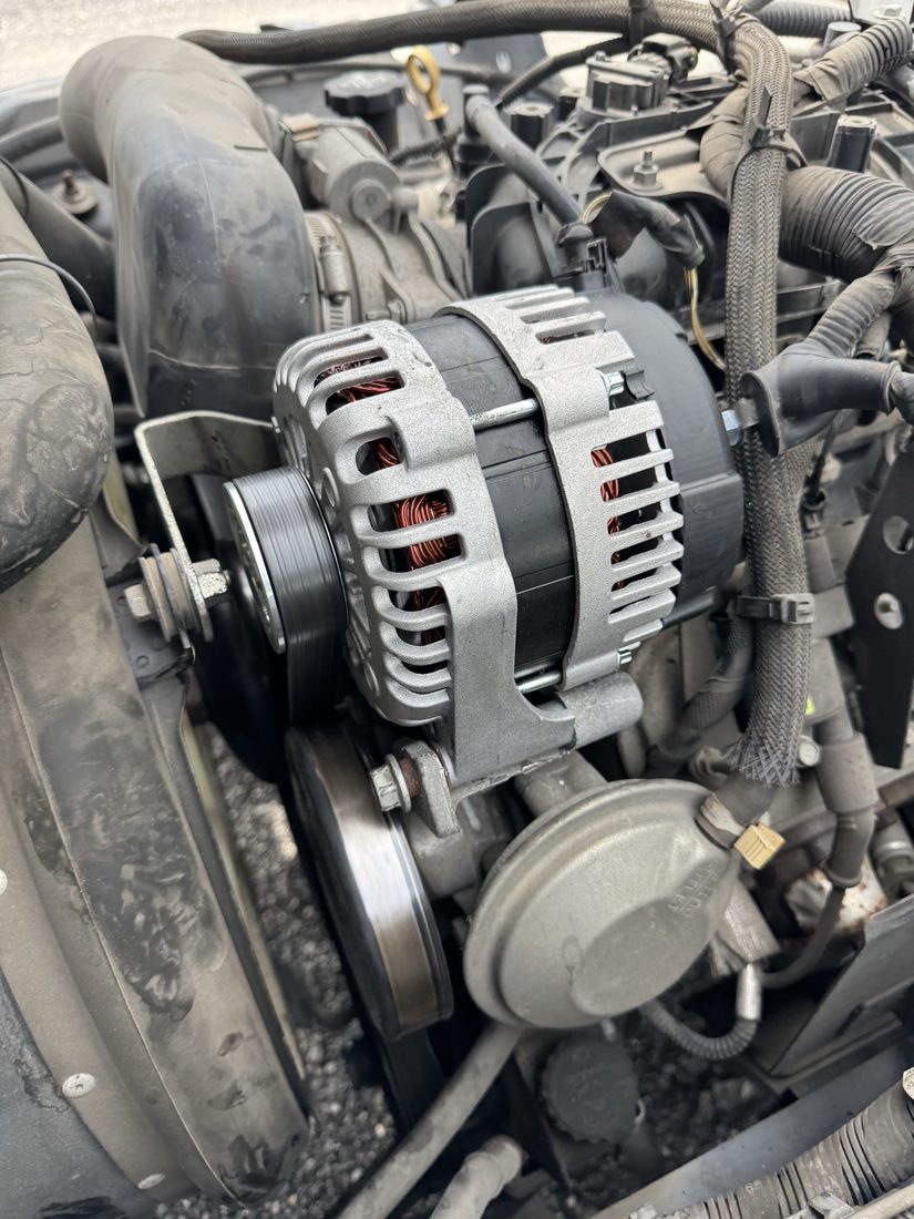 Newly installed alternator in an engine bay