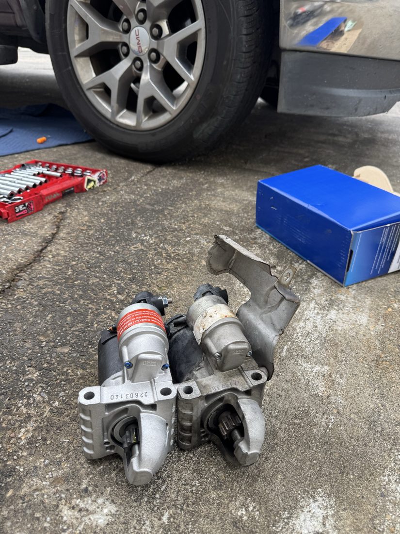 New and old starter motors side by side on the ground